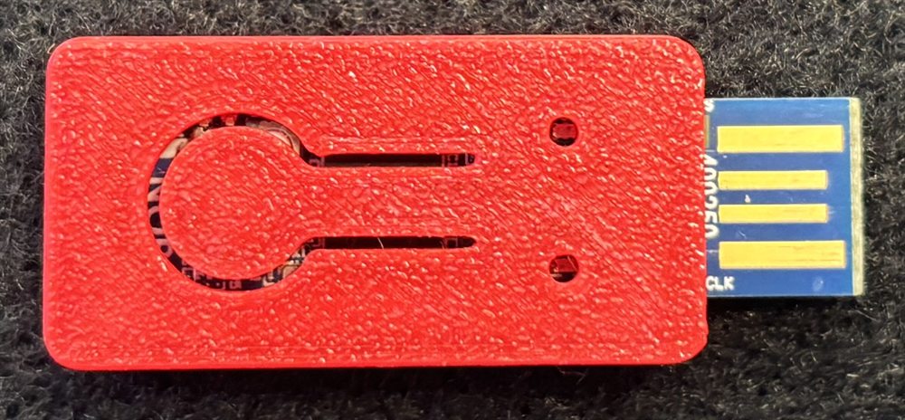 The Bluetooth USB dongle, a red printed housing with the USB contacts exposed